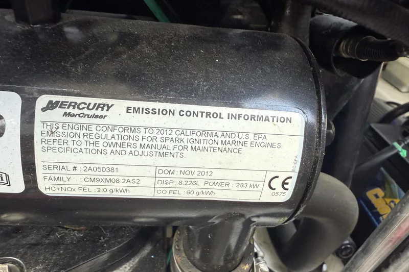 Slide: The Image of Mercury engine emission control label on 2013 Sea Ray 300 Sundeck, detailing compliance and specifications. - 11