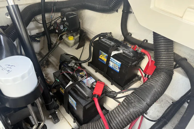 Slide: The Image of Engine compartment of 2013 Sea Ray 300 Sundeck with batteries and wiring. - 13