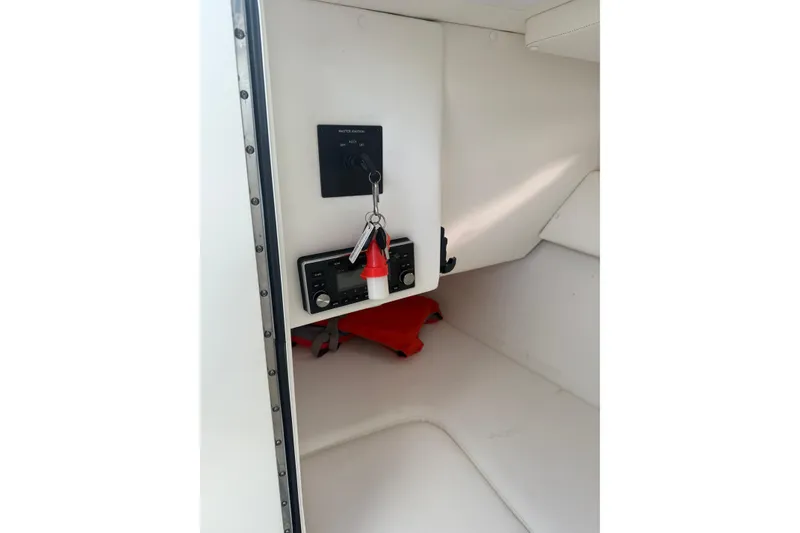 Slide: The Image of Interior view of a 2013 Sea Ray 300 Sundeck boat with control panel and keys. - 16