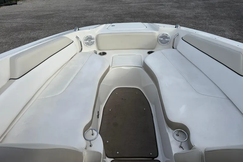 Slide: The Image of 2013 Sea Ray 300 Sundeck interior with white seating and cup holders. - 17