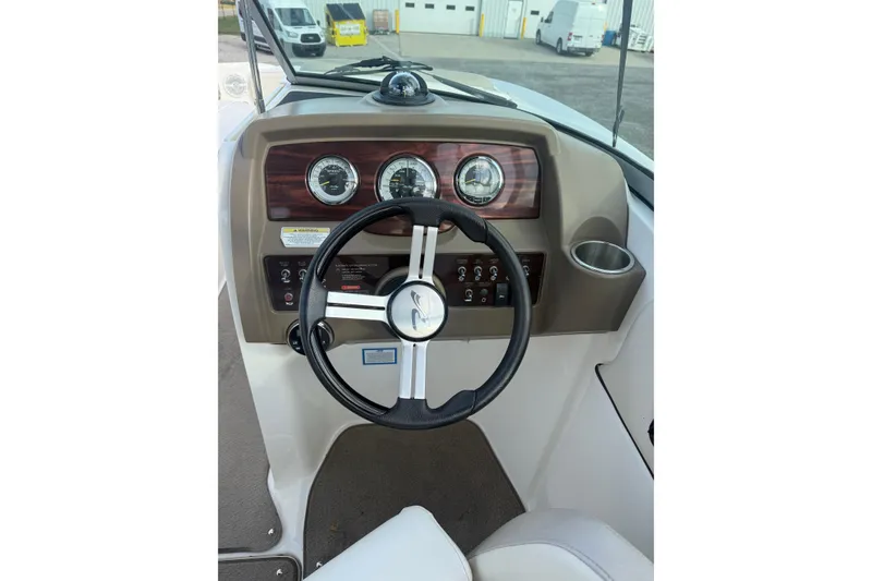 Slide: The Image of Steering console of 2013 Sea Ray 300 Sundeck boat with gauges and controls. - 19