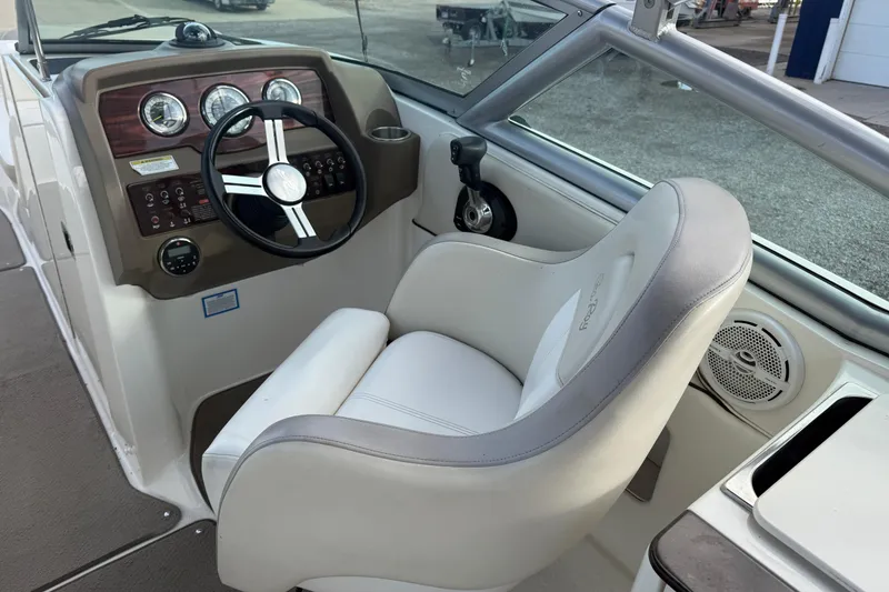 Slide: The Image of 2013 Sea Ray 300 Sundeck helm with steering wheel and comfortable captain's chair. - 20