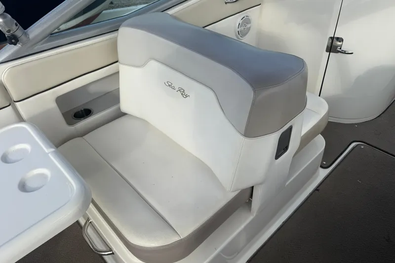Slide: The Image of 2013 Sea Ray 300 Sundeck interior seating with white and gray upholstery. - 21