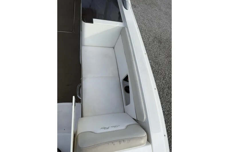 Slide: The Image of 2013 Sea Ray 300 Sundeck boat seating area with white upholstery. - 22