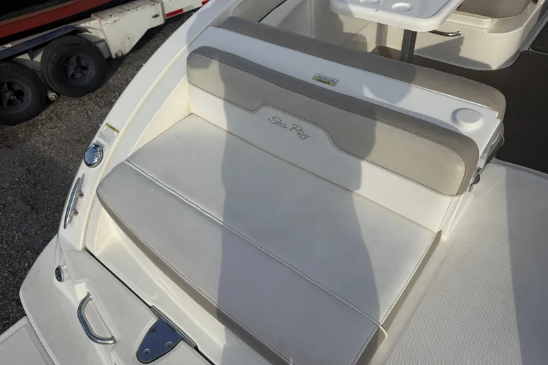 Slide: The Image of 2013 Sea Ray 300 Sundeck boat seating area with beige cushions and table. - 24
