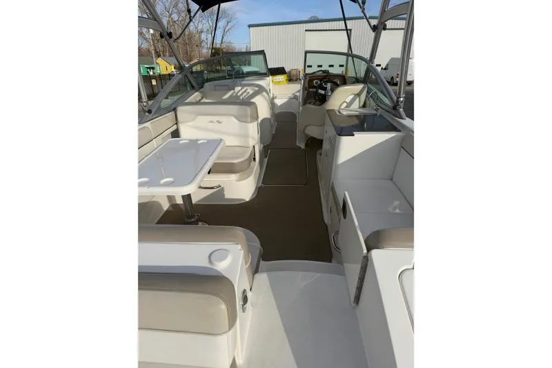 Slide: The Image of 2013 Sea Ray 300 Sundeck interior with seating and table, showcasing luxury and comfort. - 25