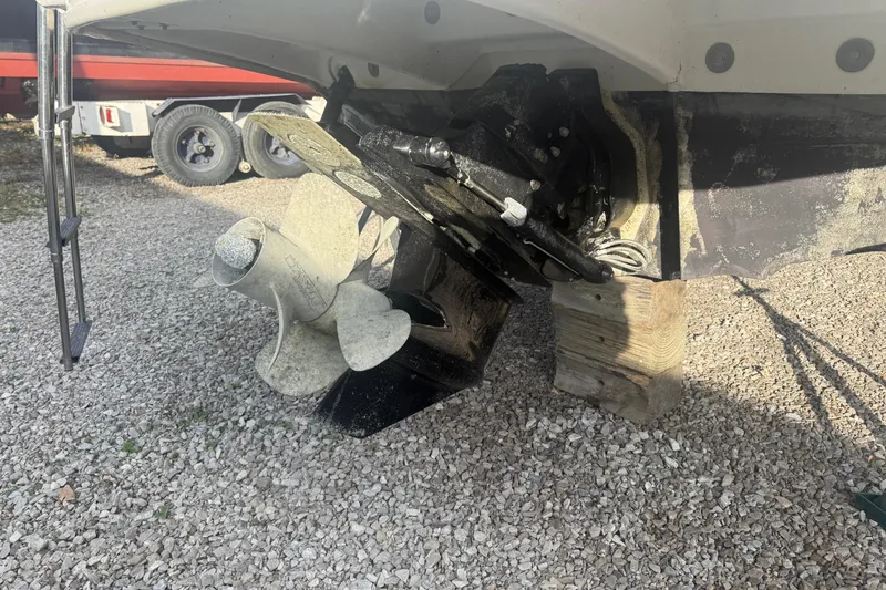 Slide: The Image of 2013 Sea Ray 300 Sundeck boat propeller and stern drive on gravel. - 29