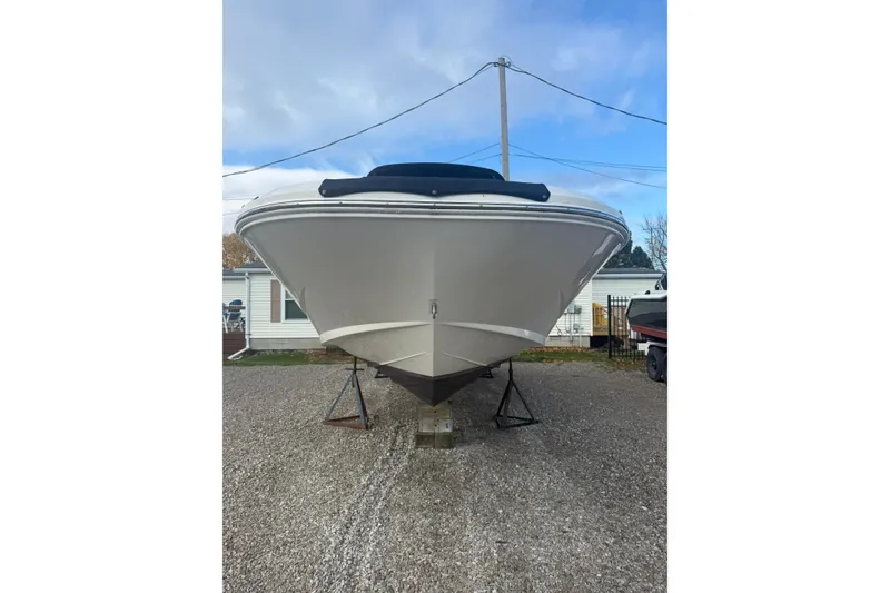 Slide: The Image of 2013 Sea Ray 300 Sundeck boat on stands, front view, outdoors. - 31