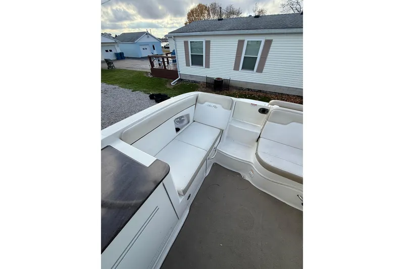 Slide: The Image of 2013 Sea Ray 300 Sundeck boat interior with white seating and outdoor view. - 6