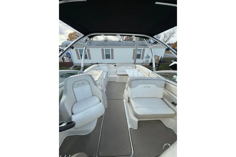 Slide: The Image of 2013 Sea Ray 300 Sundeck interior with white seating and canopy. - 7