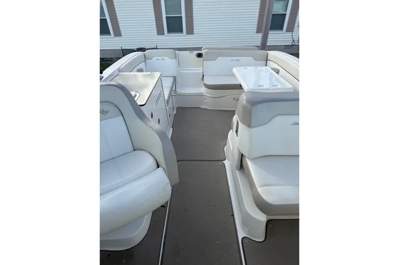 Slide: The Image of 2013 Sea Ray 300 Sundeck interior with white seating and table. - 8