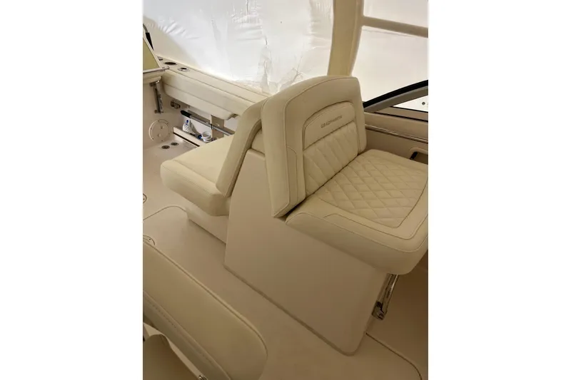 Slide: The Image of 2024 Grady-White Freedom 235 boat interior with luxurious beige seating. - 7
