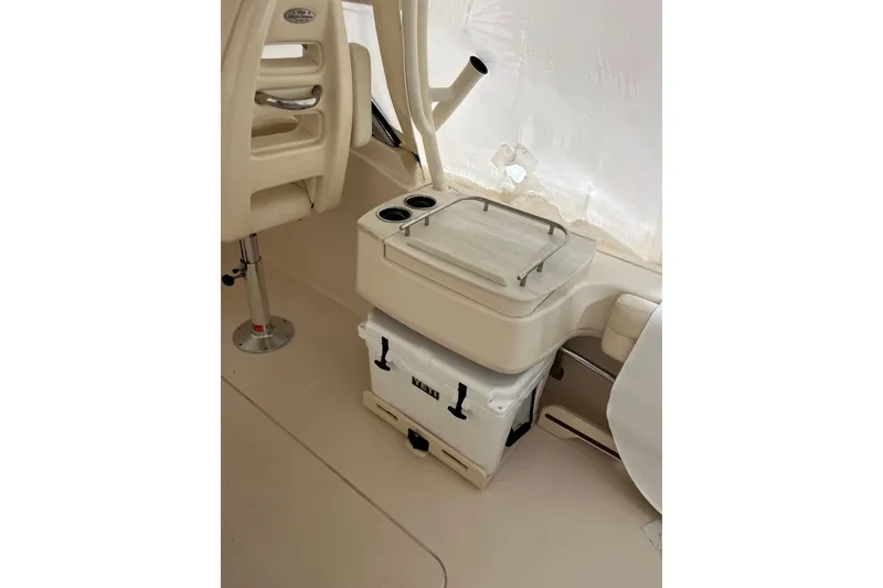 Slide: The Image of 2024 Grady-White Freedom 235 boat interior with seating and cooler storage. - 8