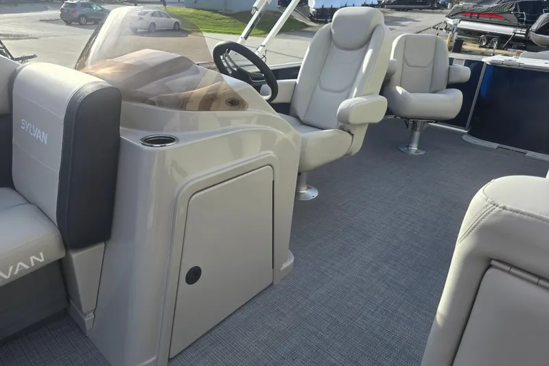 Slide: The Image of 2025 Sylvan Mirage Fish 8522 Party Fish boat interior with plush seating and steering console. - 17