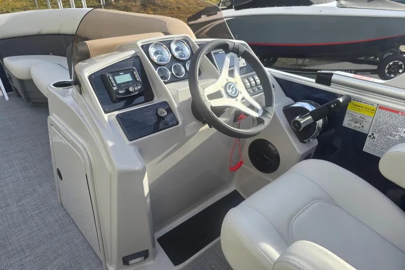 Slide: The Image of 2025 Sylvan Mirage Fish 8522 Party Fish boat dashboard with steering wheel and controls. - 19