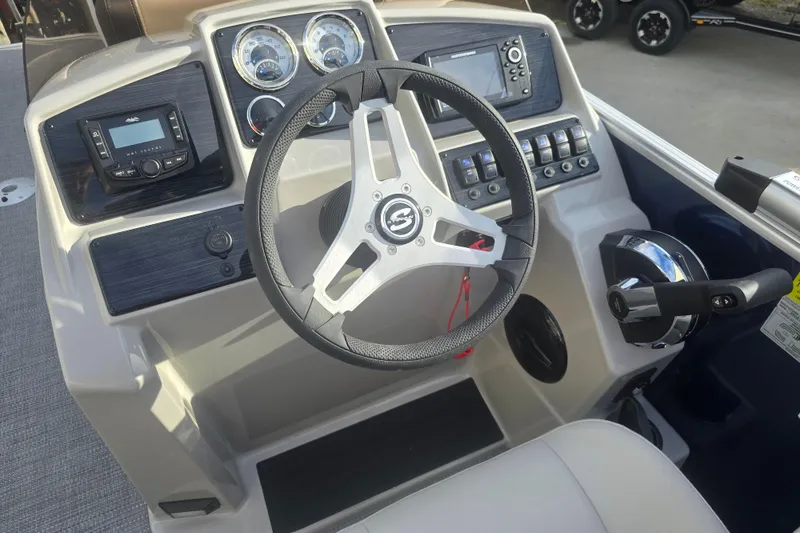 Slide: The Image of 2025 Sylvan Mirage Fish 8522 Party Fish boat dashboard with steering wheel and controls. - 20