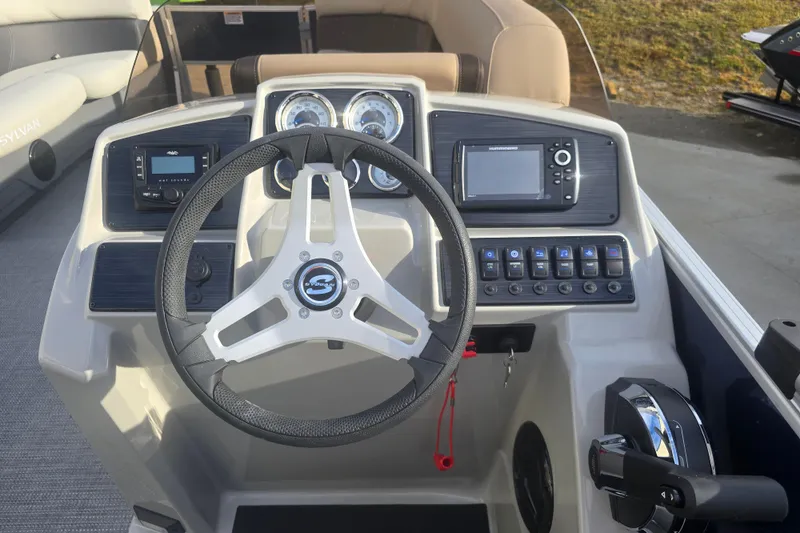 Slide: The Image of 2025 Sylvan Mirage Fish 8522 Party Fish boat dashboard with steering wheel and control panel. - 21