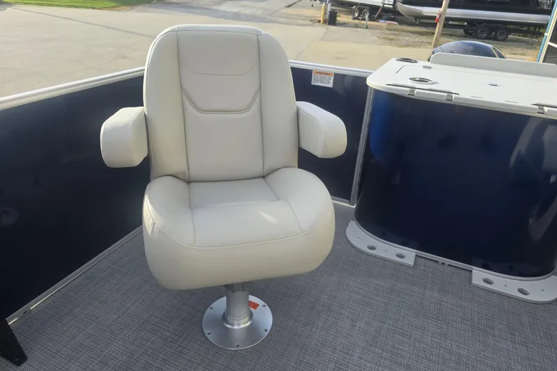 Slide: The Image of 2025 Sylvan Mirage Fish 8522 Party Fish boat seat, beige upholstery, outdoor setting. - 28