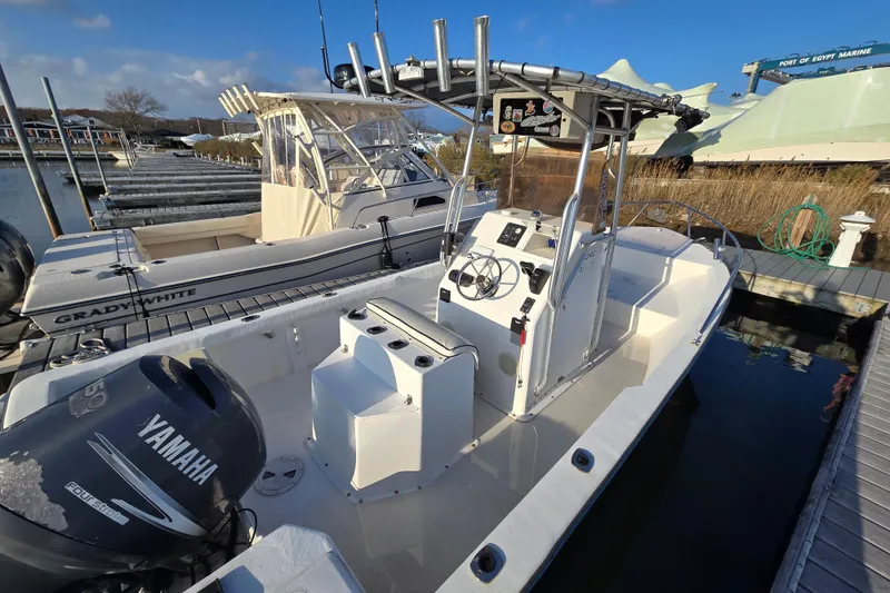 Slide: The Image of 2007 Cape Craft 22 Center Console boat docked with Yamaha engine, clear sky background. - 1