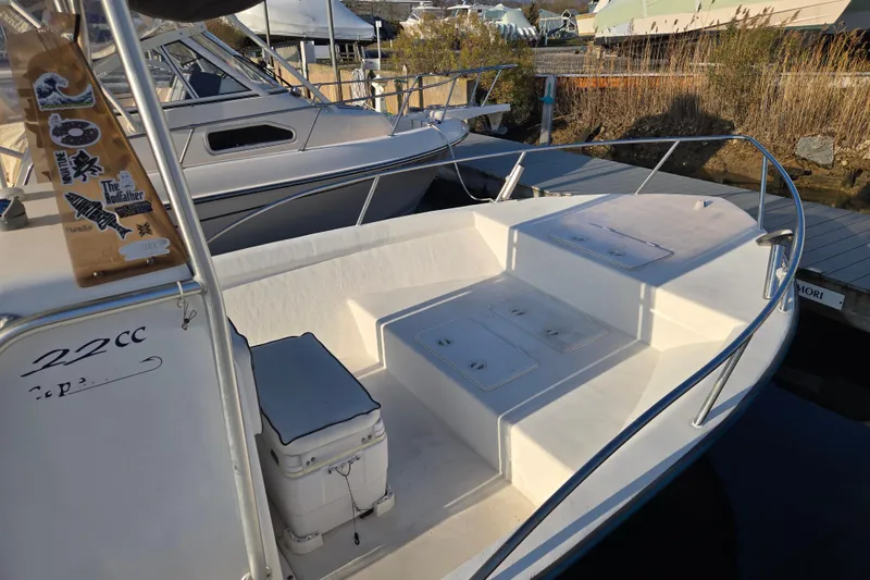 Slide: The Image of 2007 Cape Craft 22 Center Console boat docked, featuring spacious seating and storage. - 2