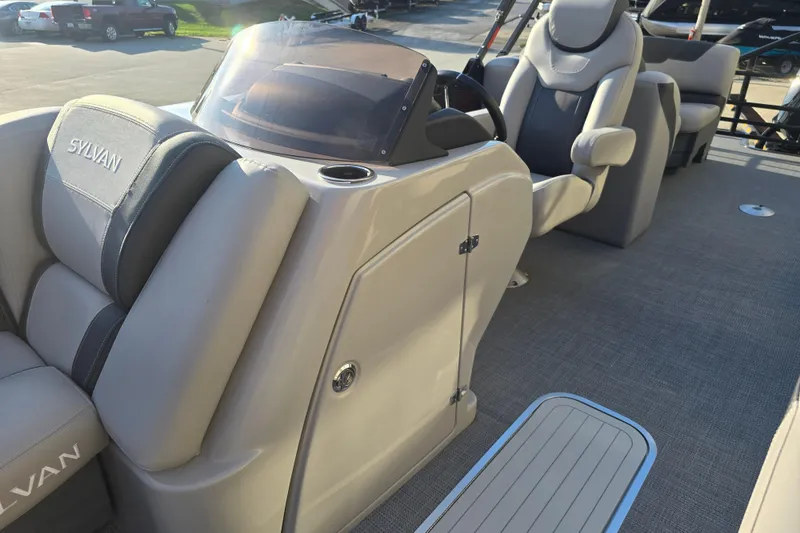 Slide: The Image of 2024 Sylvan L3 LZ boat interior with plush seating and modern dashboard. - 16