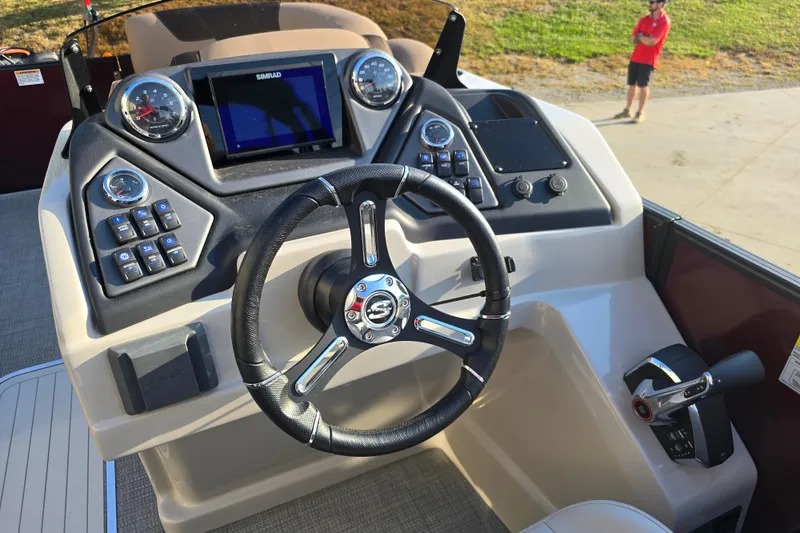 Slide: The Image of 2024 Sylvan L3 LZ boat dashboard with steering wheel and control panel. - 18