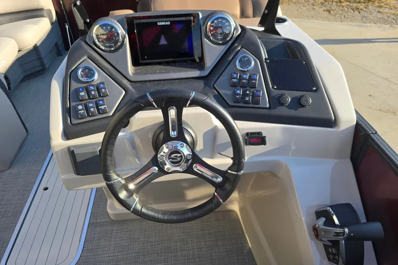 Slide: The Image of 2024 Sylvan L3 LZ boat dashboard with steering wheel and control panel. - 19
