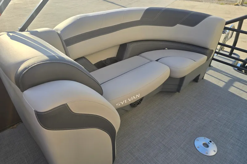 Slide: The Image of 2024 Sylvan L3 LZ boat interior with gray and black cushioned seating. - 24