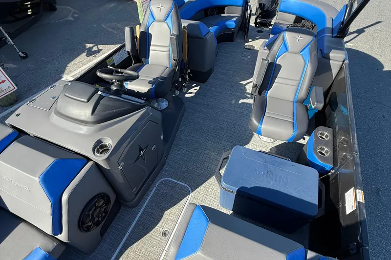 Slide: The Image of 2024 Berkshire 25RFX STS boat interior with blue and gray seating. - 10