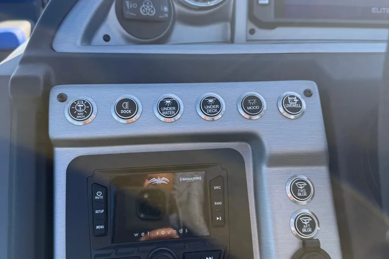 Slide: The Image of 2024 Berkshire 25RFX STS dashboard with controls and gauges, featuring power and horn buttons. - 14
