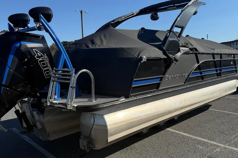 Slide: The Image of 2024 Berkshire 25RFX STS pontoon boat with sleek black design and modern features. - 4
