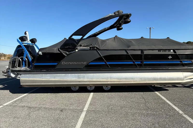 Slide: The Image of 2024 Berkshire 25RFX STS pontoon boat in parking lot, side view. - 5