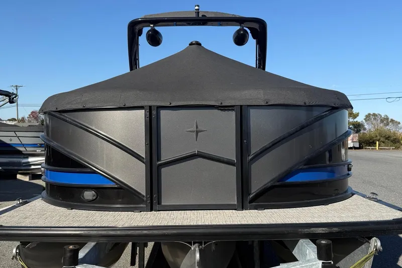 Slide: The Image of 2024 Berkshire 25RFX STS pontoon boat with powerful outboard motor in a parking lot. - 7