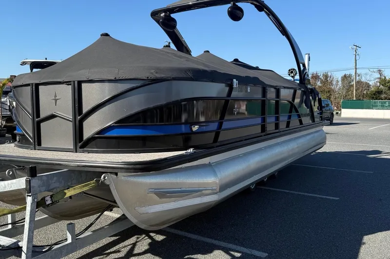 Slide: The Image of 2024 Berkshire 25RFX STS pontoon boat with blue and gray seating, docked outdoors. - 8