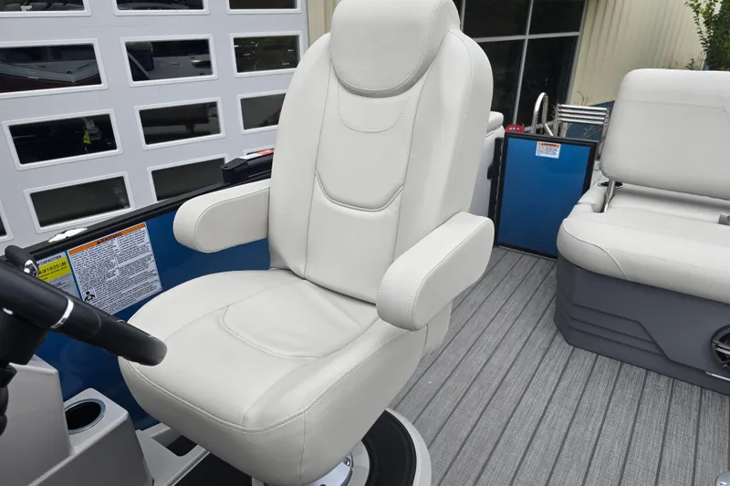 Slide: The Image of 2024 Sylvan Mirage X X5 CLZ boat interior with plush captain's chair and seating. - 15