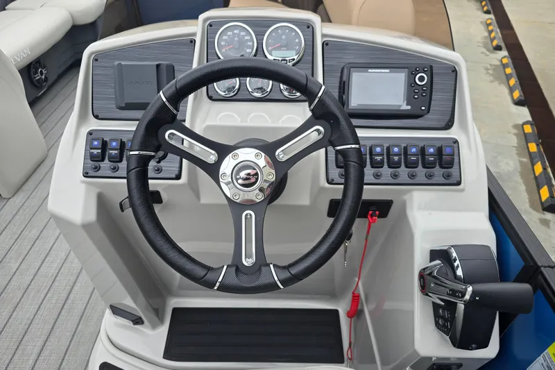 Slide: The Image of 2024 Sylvan Mirage X X5 CLZ boat dashboard with steering wheel and controls. - 17