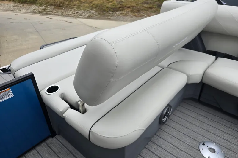 Slide: The Image of 2024 Sylvan Mirage X X5 CLZ boat interior with plush seating and cup holder. - 20