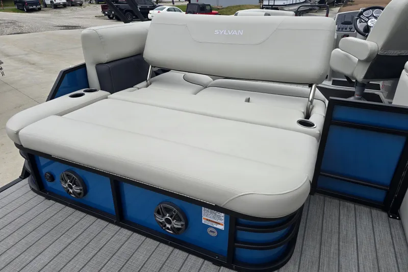 Slide: The Image of 2024 Sylvan Mirage X X5 CLZ boat with plush seating and integrated speakers. - 24