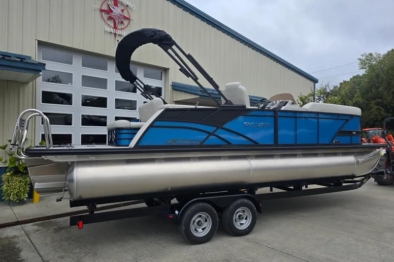 Slide: The Image of 2024 Sylvan Mirage X X5 CLZ pontoon boat on trailer outside marine building. - 5