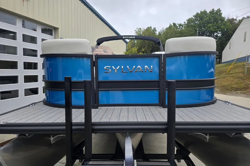 Slide: The Image of 2024 Sylvan Mirage X X5 CLZ pontoon boat, blue exterior, parked outdoors. - 8
