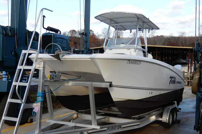 The Image of 2022 Twin Vee 240 CC GFX Limited Edition boat on trailer at marina. - 0