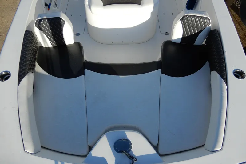 Slide: The Image of 2022 Twin Vee 240 CC GFX Limited Edition boat interior with black and white seating. - 12