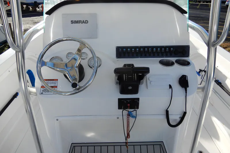 Slide: The Image of 2022 Twin Vee 240 CC GFX Limited Edition boat console with steering wheel and controls. - 20
