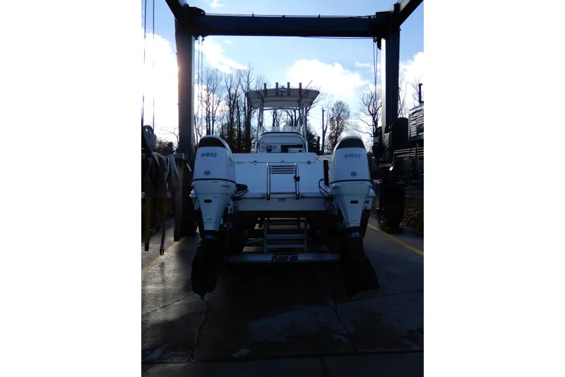 Slide: The Image of 2022 Twin Vee 240 CC GFX Limited Edition boat with dual engines on a lift. - 5