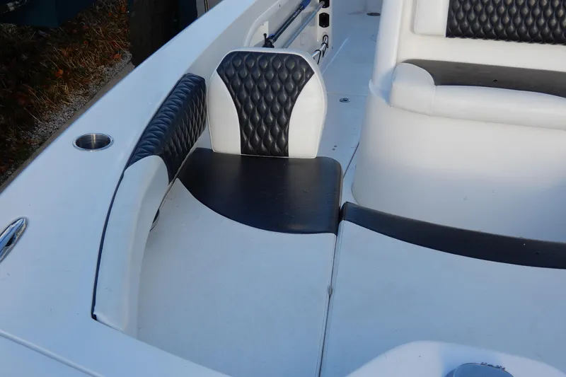 Slide: The Image of 2022 Twin Vee 240 CC GFX Limited Edition boat interior with black and white seating. - 8