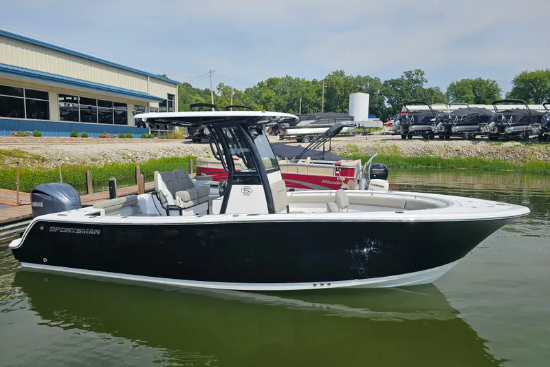 The Image of 2025 Sportsman Open 232 Center Console boat docked at marina. - 0