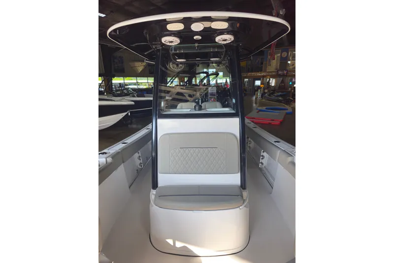 Slide: The Image of 2025 Sportsman Open 232 Center Console boat interior with seating and console view. - 10