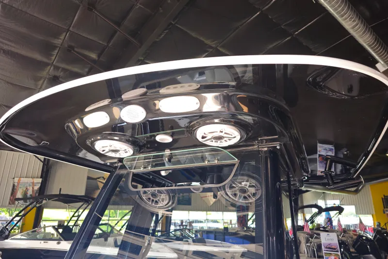 Slide: The Image of 2025 Sportsman Open 232 Center Console boat interior with modern lighting and speakers. - 11