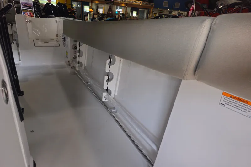 Slide: The Image of 2025 Sportsman Open 232 Center Console interior with cushioned seating and storage compartments. - 13