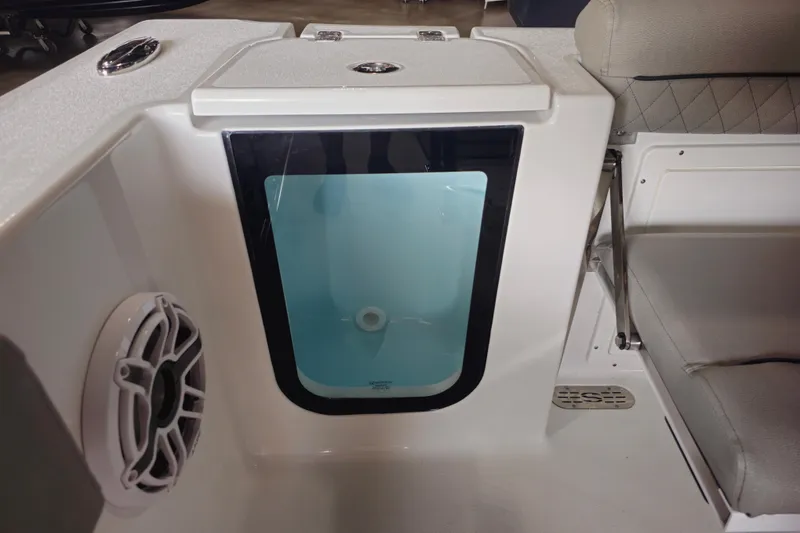 Slide: The Image of 2025 Sportsman Open 232 Center Console boat interior with storage compartment and speaker. - 15